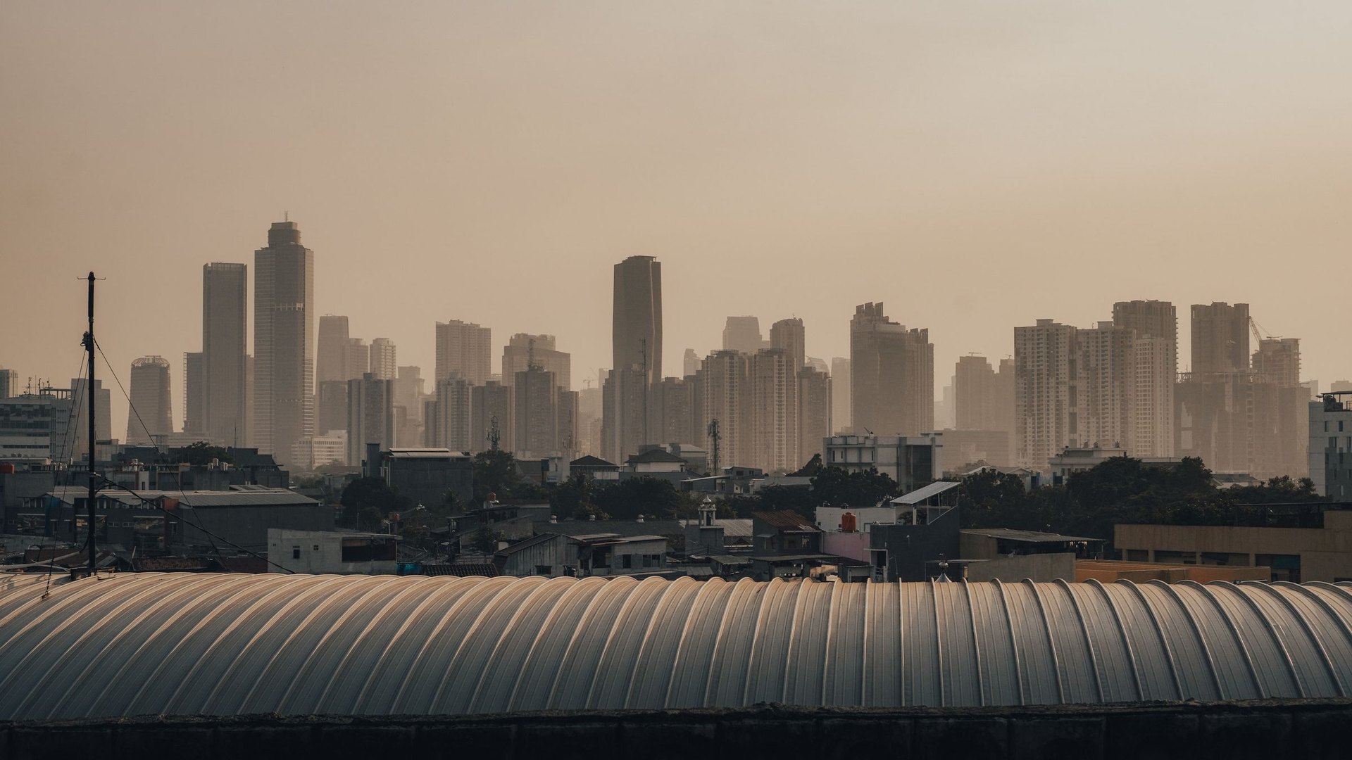 Warehouse roof against the Jakarta skyline at dusk, Indonesia